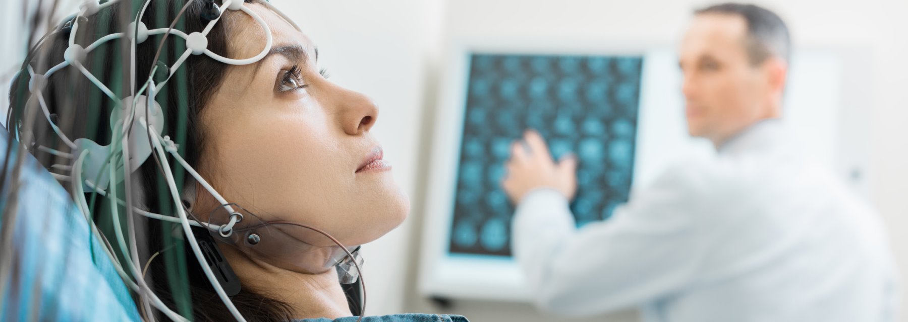 Woman focuses on a computer screen with wires visible around her at Tampa Florida