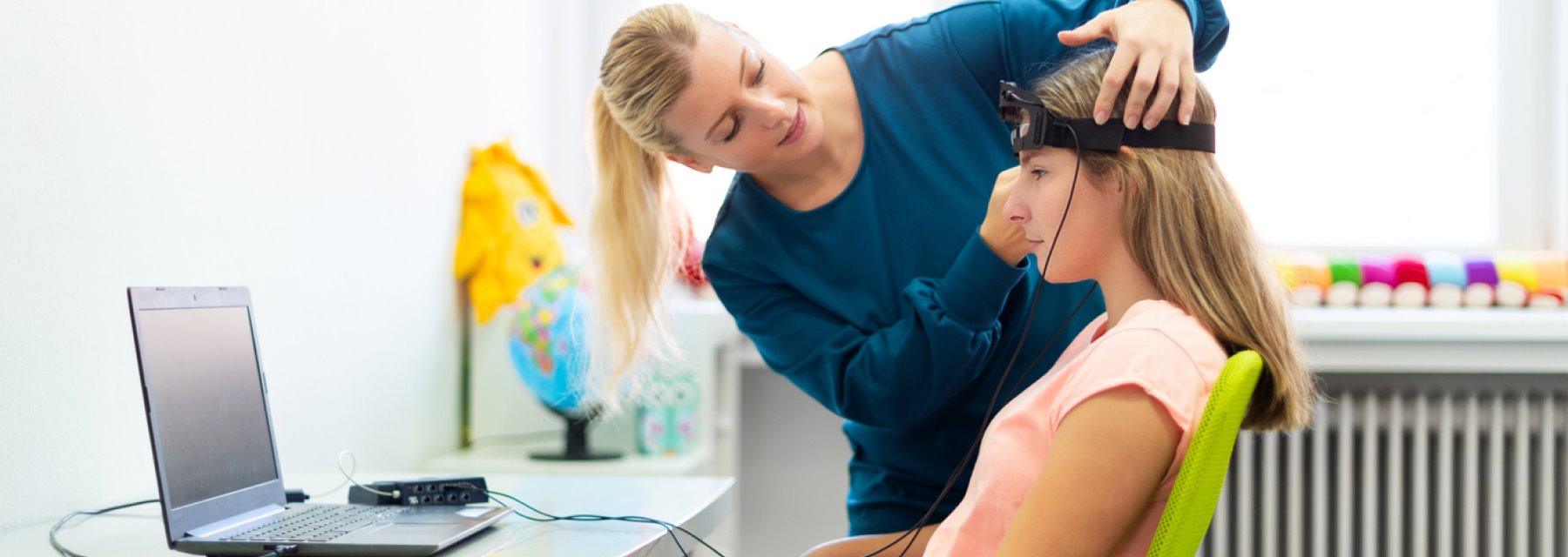 Woman gently places a headset on a child's head at Tampa Florida